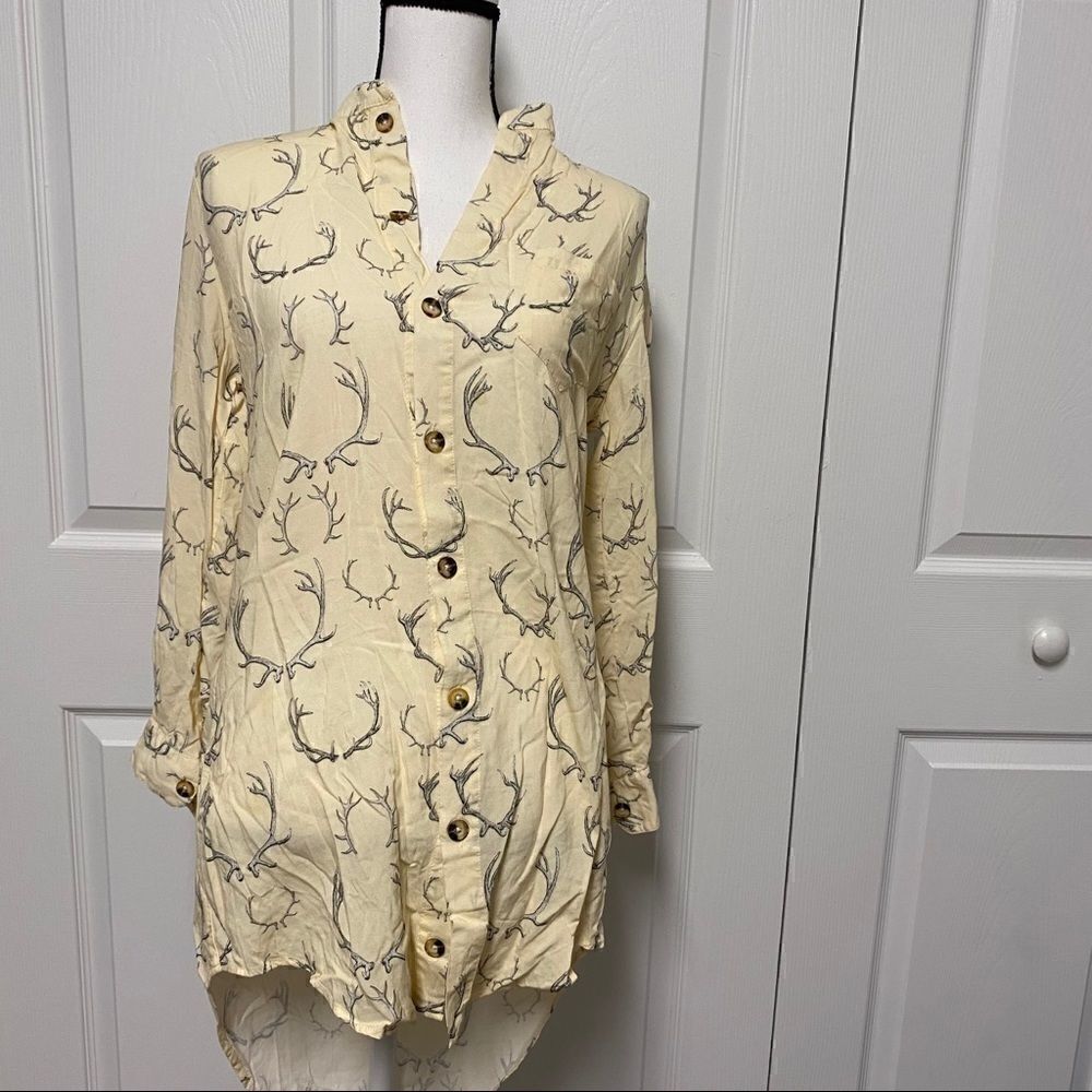 unique antlers on an ivory colored button down top